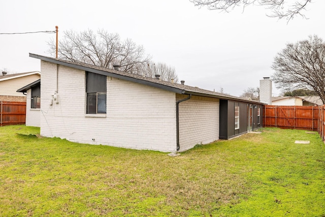 view of side of property with a yard