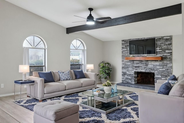 living room with hardwood / wood-style floors, a fireplace, lofted ceiling with beams, and ceiling fan