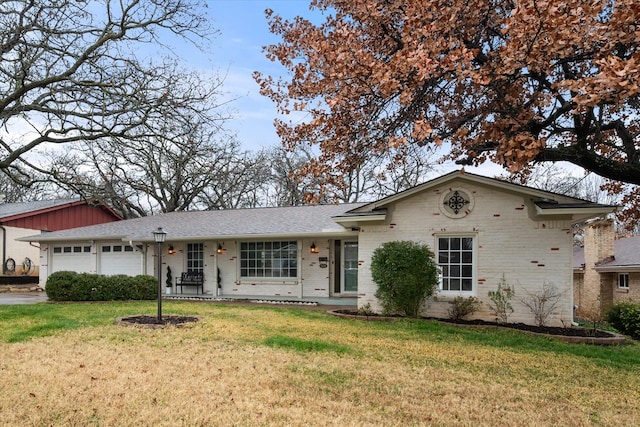 single story home featuring a garage and a front yard