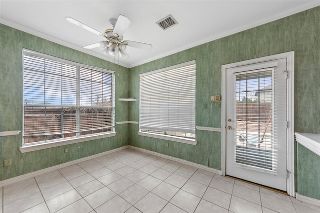 interior space with ornamental molding, plenty of natural light, light tile patterned floors, and ceiling fan