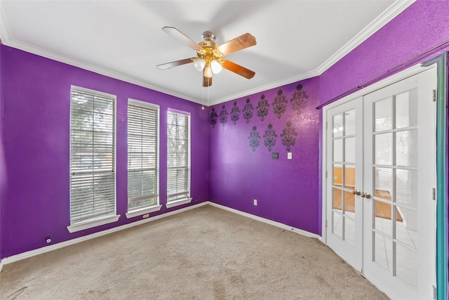 empty room featuring french doors, ornamental molding, and carpet floors