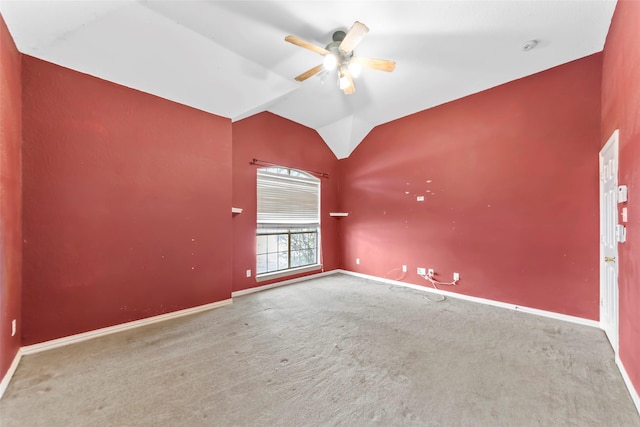 unfurnished room featuring lofted ceiling, carpet flooring, and ceiling fan