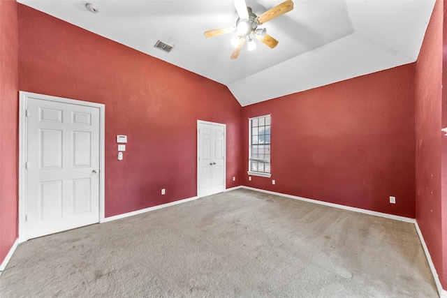 carpeted empty room featuring ceiling fan and vaulted ceiling