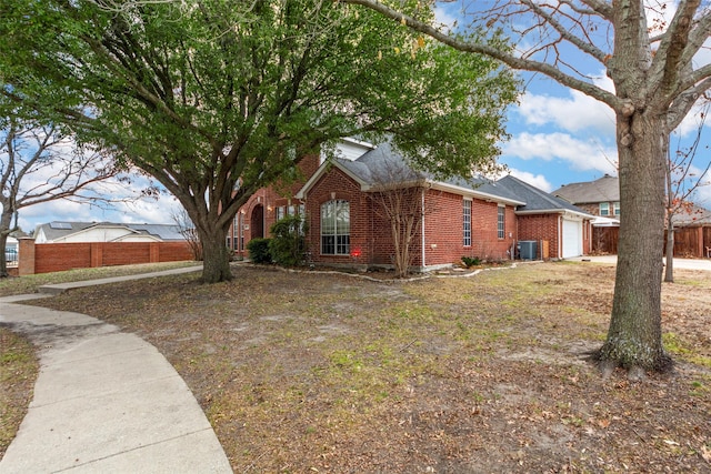 view of side of home with a garage and central air condition unit