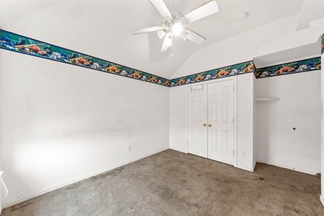 unfurnished bedroom with carpet floors, vaulted ceiling, a closet, and ceiling fan