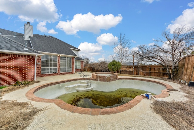 view of swimming pool with an in ground hot tub and a patio