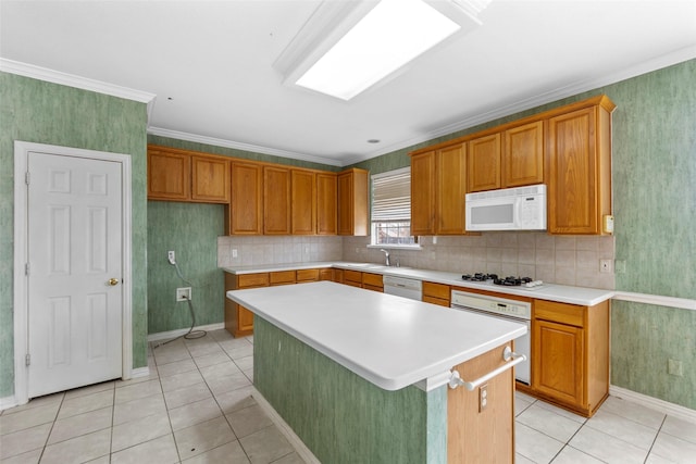 kitchen with crown molding, white appliances, a kitchen island, and light tile patterned floors