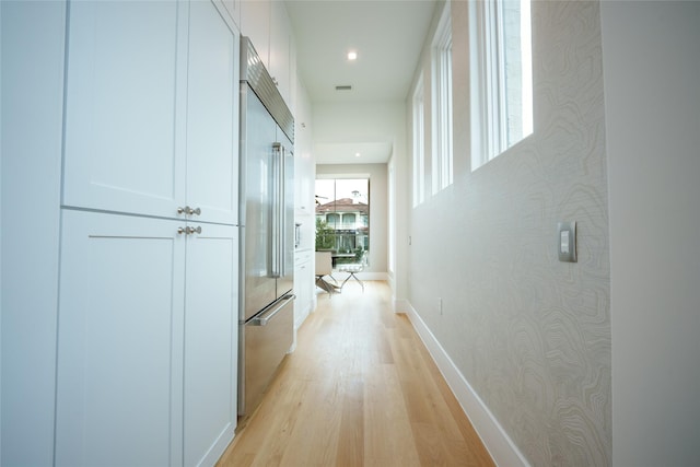 corridor with light wood-type flooring