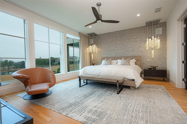 bedroom featuring hardwood / wood-style flooring and ceiling fan