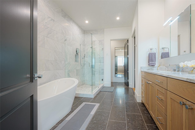 bathroom with vanity and independent shower and bath