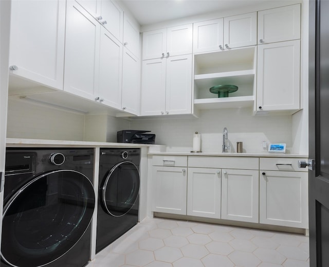 laundry area with cabinets, sink, and independent washer and dryer