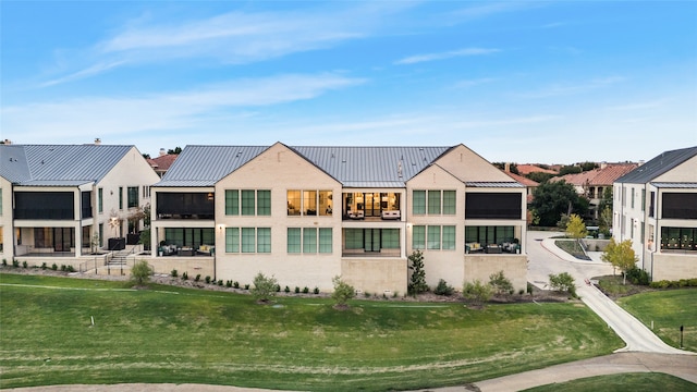 back of house featuring a lawn