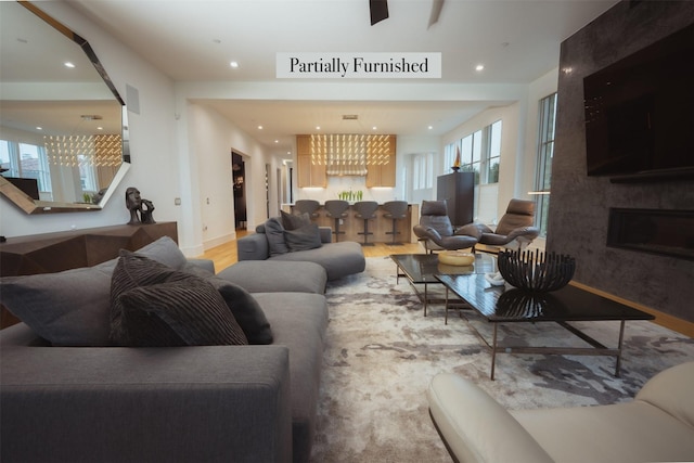 living room with a large fireplace and hardwood / wood-style floors