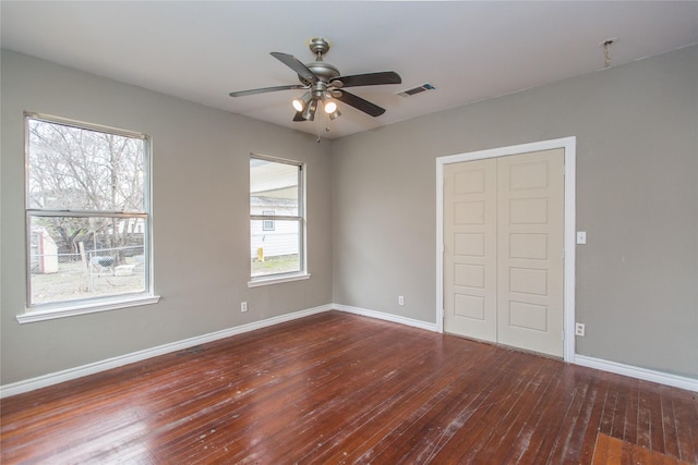 spare room featuring dark hardwood / wood-style floors and ceiling fan