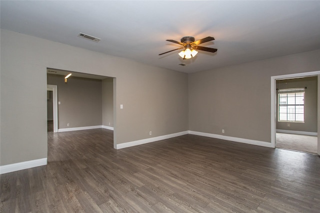 unfurnished room with ceiling fan and dark hardwood / wood-style flooring