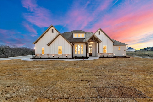 modern inspired farmhouse with a yard