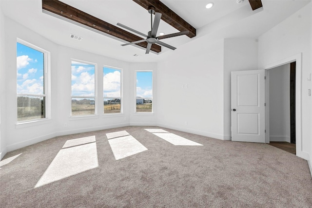 carpeted empty room featuring beam ceiling and ceiling fan