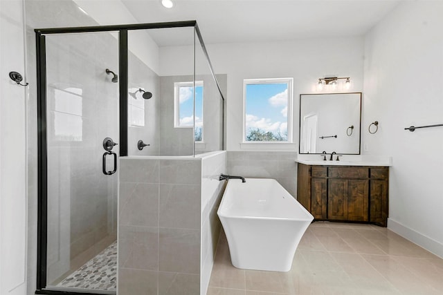 bathroom with independent shower and bath, vanity, and tile patterned flooring