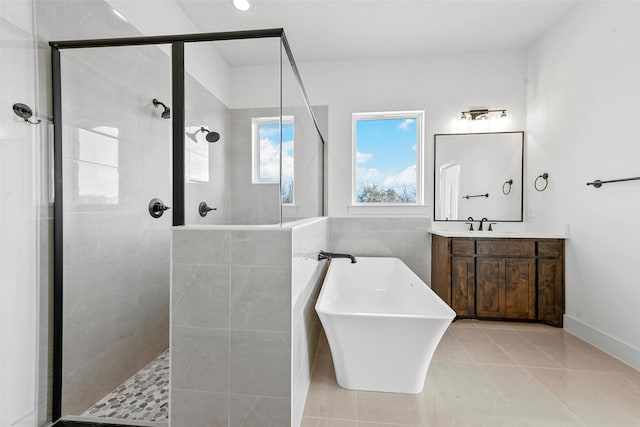 bathroom with vanity, tile patterned flooring, and plus walk in shower