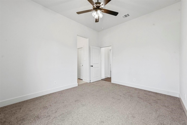 carpeted spare room with ceiling fan