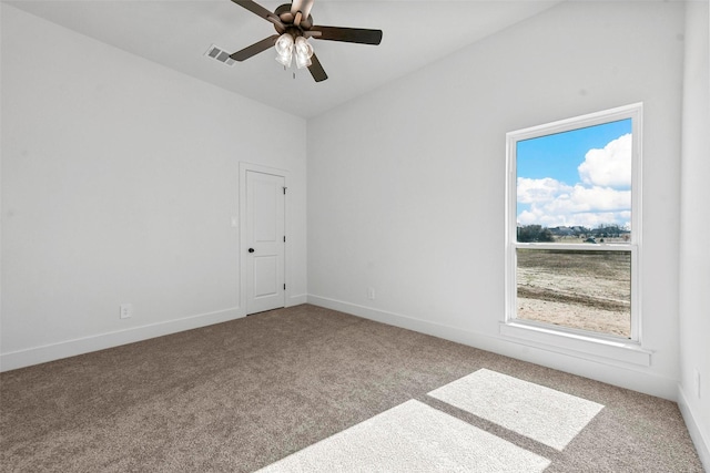 carpeted spare room with ceiling fan