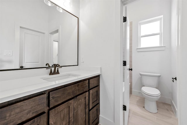 bathroom featuring tile patterned floors, vanity, and toilet