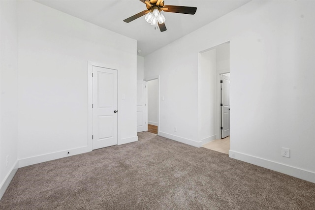 spare room featuring light colored carpet and ceiling fan