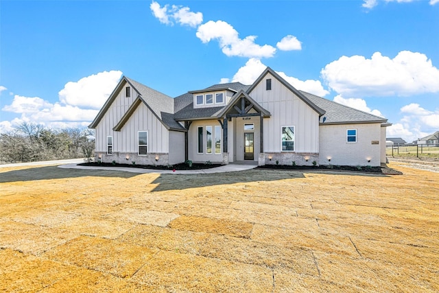 modern inspired farmhouse with a front lawn