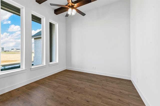 empty room with ceiling fan, plenty of natural light, and dark hardwood / wood-style floors