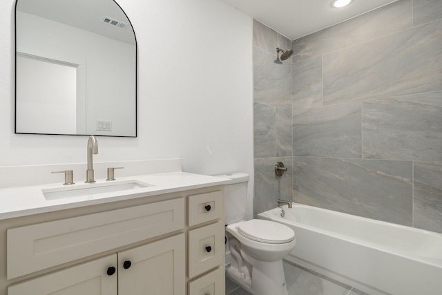 full bathroom featuring vanity, toilet, and tiled shower / bath