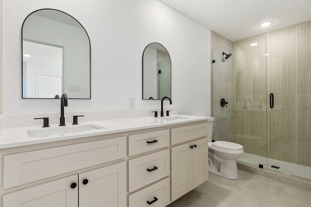 bathroom featuring vanity, toilet, tile patterned floors, and a shower with shower door