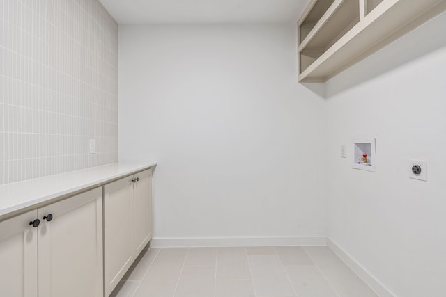 clothes washing area with electric dryer hookup, light tile patterned floors, and hookup for a washing machine