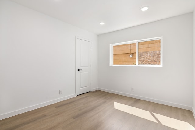 empty room with hardwood / wood-style floors