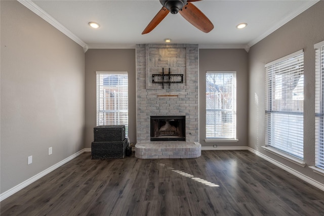 unfurnished living room with dark wood-type flooring, a fireplace, ornamental molding, and ceiling fan