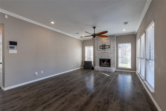 unfurnished living room featuring ceiling fan, crown molding, a fireplace, and dark wood-type flooring