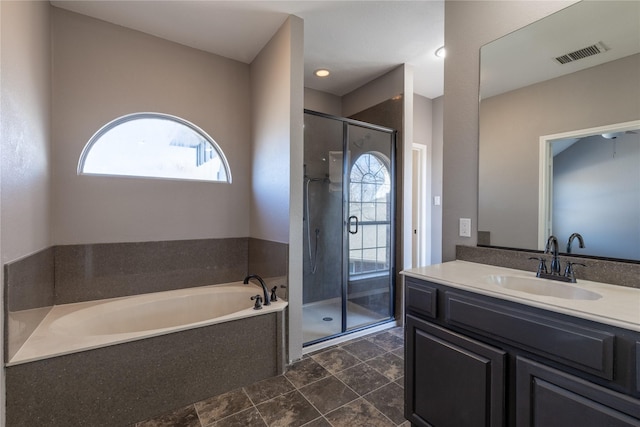 bathroom featuring vanity and separate shower and tub