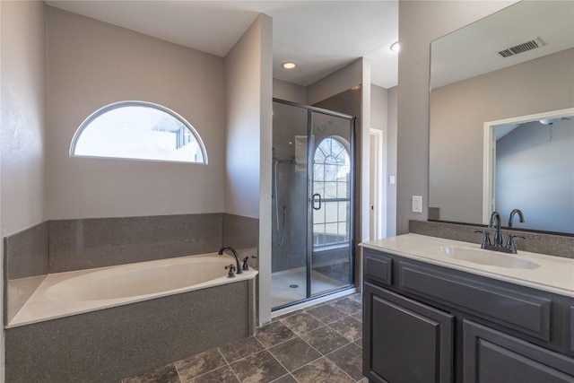 bathroom featuring vanity and plus walk in shower