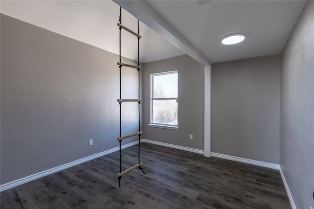 unfurnished room with dark hardwood / wood-style flooring