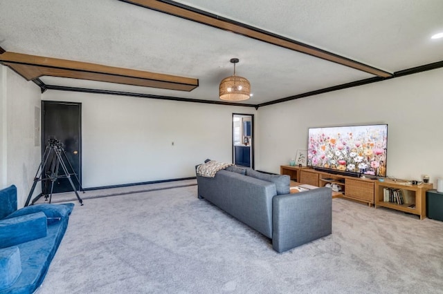 carpeted living room with crown molding and beam ceiling