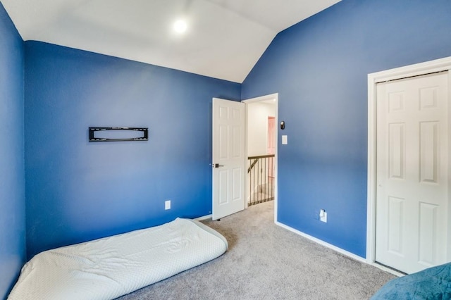 carpeted bedroom with vaulted ceiling