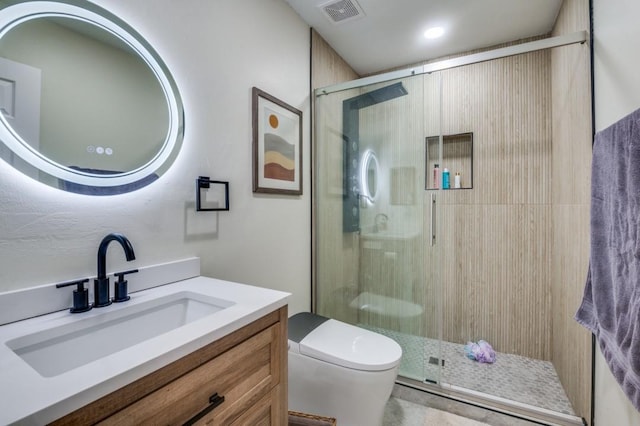 bathroom featuring vanity, an enclosed shower, and toilet