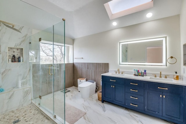 bathroom with walk in shower, toilet, a skylight, tile walls, and vanity