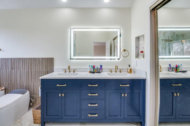 bathroom featuring vanity, a shower with shower door, and toilet