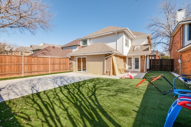 back of property featuring a lawn, a patio, and french doors