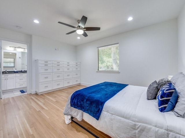 bedroom featuring ensuite bathroom, sink, ceiling fan, and light hardwood / wood-style flooring