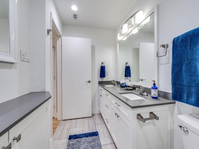 bathroom featuring vanity and toilet