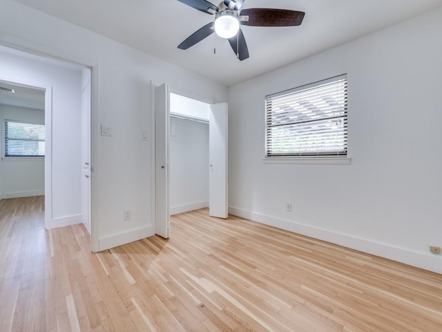 unfurnished bedroom featuring ceiling fan, light wood-type flooring, and a closet