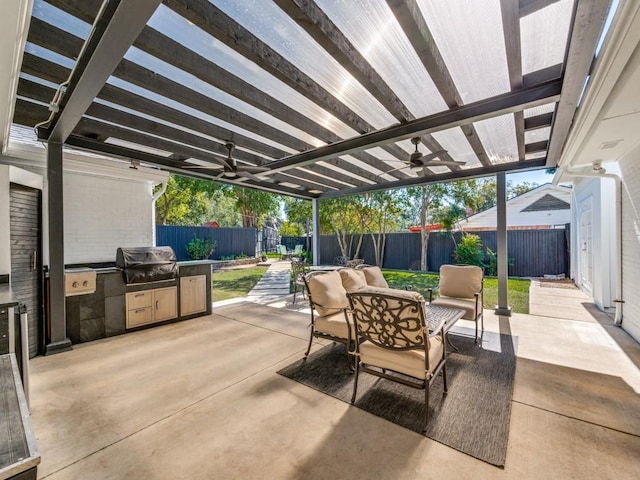 view of patio with a grill, a pergola, ceiling fan, and an outdoor kitchen