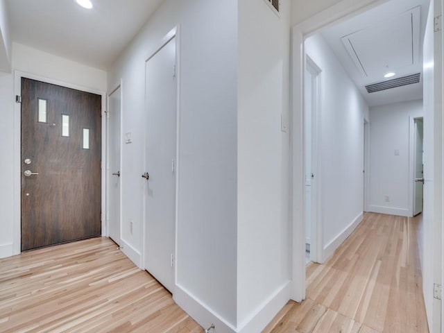 hallway with light hardwood / wood-style floors