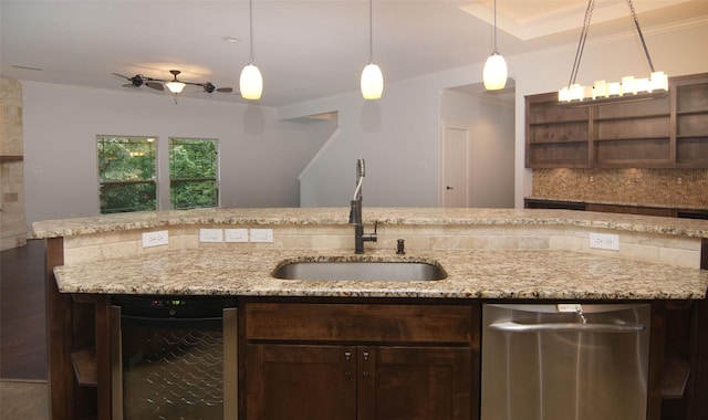 kitchen featuring sink, backsplash, hanging light fixtures, dark brown cabinets, and ornamental molding